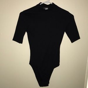 Divided black turtle neck bodysuit
